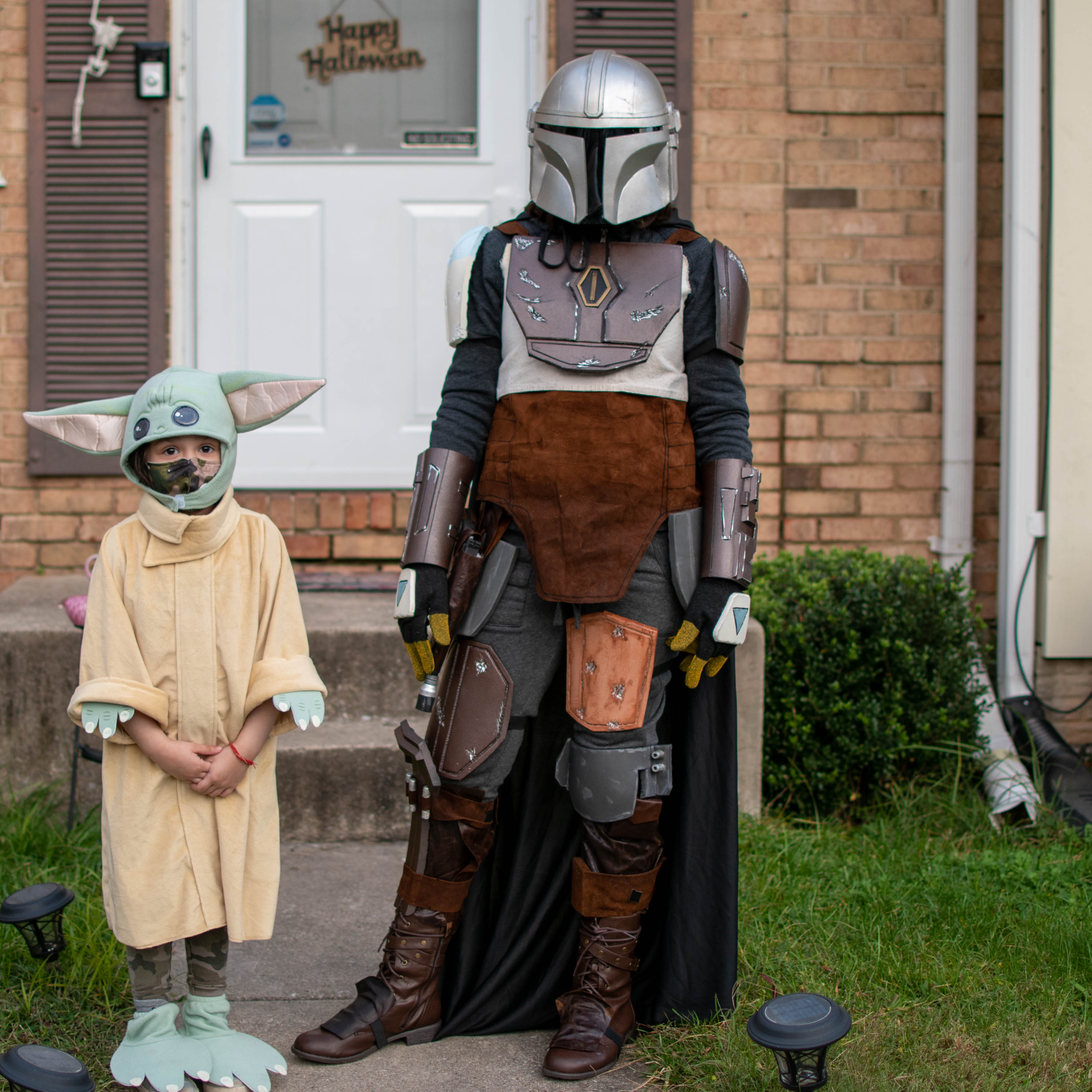 Aanya and Teagan dressed up for Halloween as The Mandalorian and Grogu